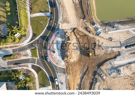 Roadworks construction site at roundabout intersection on American highway. Development of city circular transportation crossroads