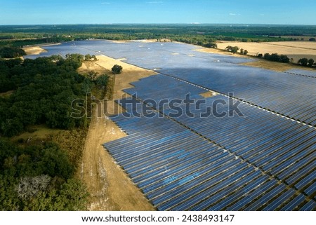 Aerial view of large sustainable electrical power plant with rows of solar photovoltaic panels for producing clean electric energy. Concept of renewable electricity with zero emission Royalty-Free Stock Photo #2438493147