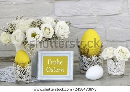 Greeting card Happy Easter: arrangement with Easter bunnies, flowers and colored Easter eggs. German inscription translated means Easter menu.