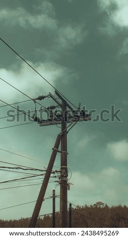 power pole (tiang listrik). Towering through the clouds Royalty-Free Stock Photo #2438495269