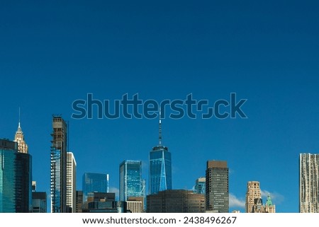 The tops of the buildings of the NYC Skyline in Lower Manhattan seen from Brooklyn on a clear blue sky day