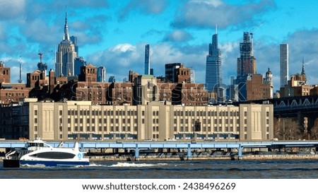 The FDR drive and NY Ferry under the Brooklyn Bridge with the Empire State building and Chrysler Building visible