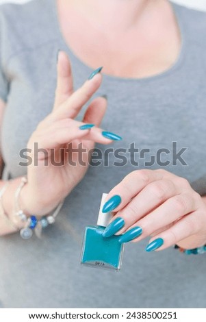 Female hand with long nails and light blue manicure