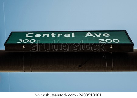A clear and minimalistic image showing a street sign for Central Avenue, set against a vivid blue sky. Ideal for themes of navigation, urban planning, and transportation.