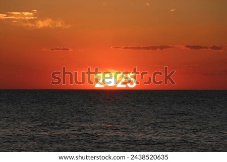 The year 2025 on the sea horizon at sunrise. Happy New Year 2025 anniversary. 2025 concept image with text on sun rising sky. Beautiful sunrise or sunset over the sea