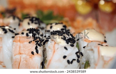White sushi with shrimp and black sesame. Stock photo of Japanese food with dish and place for text.