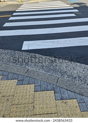 The crosswalk is equipped with braille blocks to safely assist visually impaired people