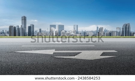 Empty Urban Road with Modern City Skyline