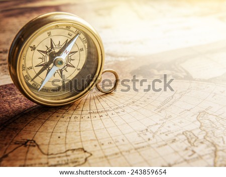 Old compass on vintage map. Retro stale. Royalty-Free Stock Photo #243859654