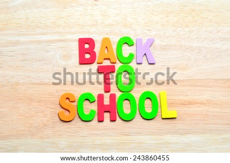 Back to School text with shadow on wooden background
