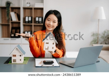 Considering buying a home, investing in real estate. Broker signs a sales agreement. agent, lease agreement, successful deal . asian woman