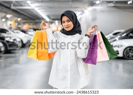 Muslim women wear hijab holding shopping bag color in supermarket. Female islamic arabic relaxation shopping. fashion lifestyle. Royalty-Free Stock Photo #2438615323