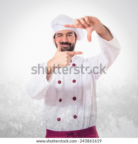 Chef focusing with his fingers on a white background