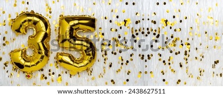 Golden foil balloon number, figure thirty-five on white with confetti background. 35th birthday card. Anniversary concept. birthday, new year celebration. banner, copy space.