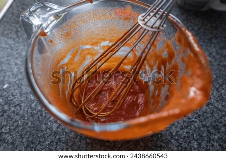 Used filthy measure jar with red sauce leftovers. Royalty-Free Stock Photo #2438660543