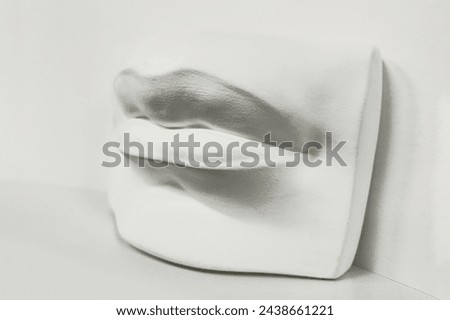 Side view Gypsum plaster cast human lips, a cast for drawing. Academic drawing - male lips, plaster cast fragment. Royalty-Free Stock Photo #2438661221
