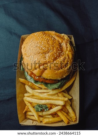 burger set containing fries and a crispy chicken burger photo from above