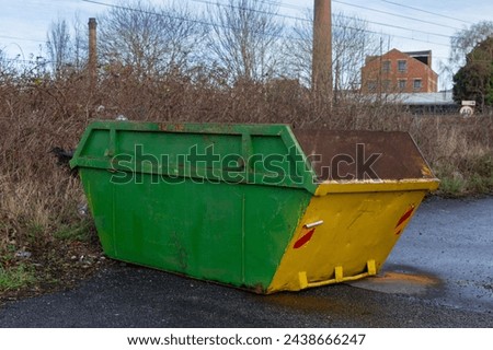 An industrial sized skip for companies to dispose of their waste and rubbish in a way that is friendly towards the environment Royalty-Free Stock Photo #2438666247