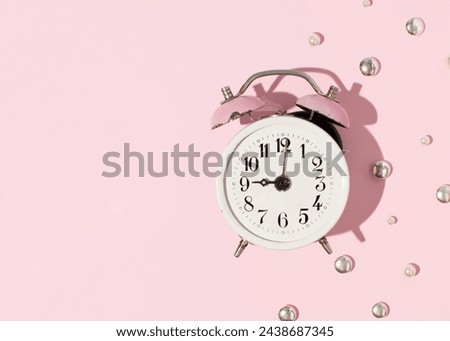 Metal alarm clock, vintage copy, creative composition, morning wake up, 9 o'clock.
