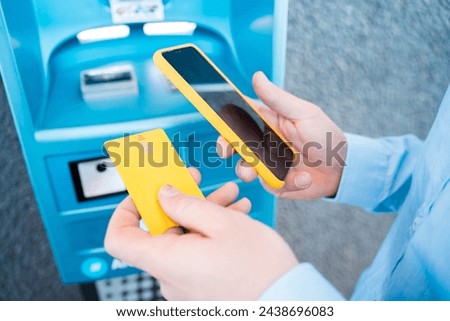 hand holding the phone with mobile wallet to pay online at the gas station. High quality photo