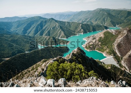 Blue green Kozjak lake surrounded by hills in the mountains of Macedonia. Large artificial lake. Breathtaking panoramic view. Royalty-Free Stock Photo #2438715053