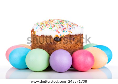 Easter cake and painted eggs closeup on white background 