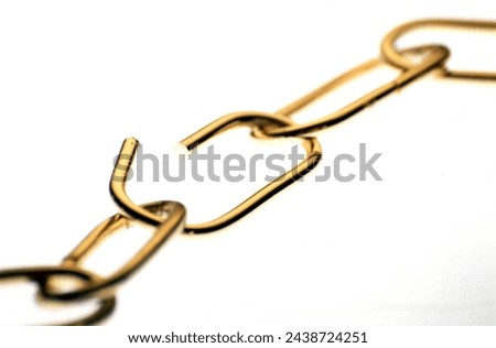 Several chain links of a tensioned chain  Royalty-Free Stock Photo #2438724251