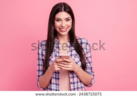 Close-up portrait of her she nice-looking attractive cute charming fascinating lovely cheerful straight-haired lady holding in hands cell free spare time isolated over pink pastel background