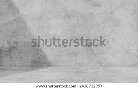 Empty grey concrete loft wall room interior studio background and floor with shadow light perspective well editing display products and text on free space cement backdrop 