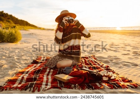 Young Woman at the Beach with Vintage Camera. Picnic, relax, weekend.