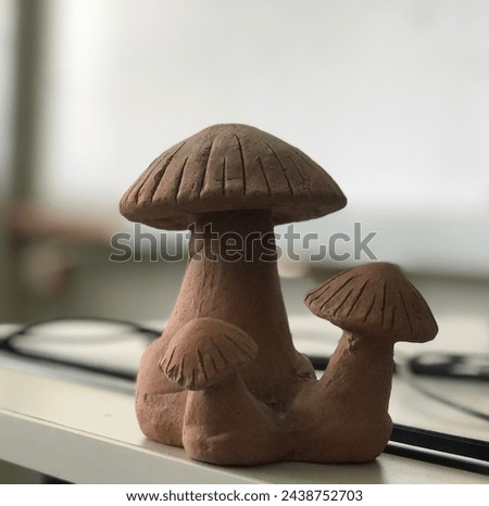 Take a photo of a mushroom sculpture, clear face, blurred background.