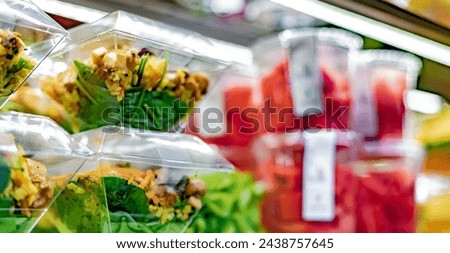 Pre-packaged ready to eat meals and fruit salads displayed in a commercial refrigerator Royalty-Free Stock Photo #2438757645
