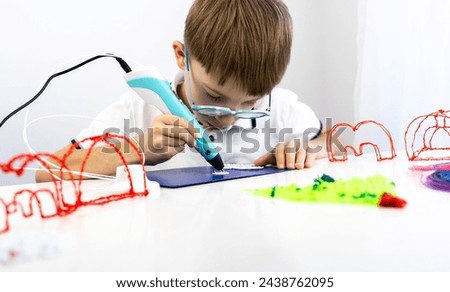 Boy playing with a 3D pen