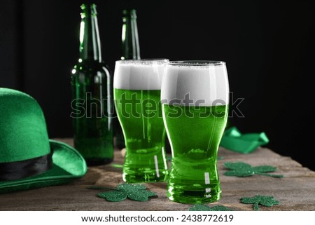 St. Patrick's day party. Green beer, decorative clover leaves and leprechaun hat on wooden table