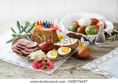 Easter traditional food with ham, eggs and bread. Holidays background. Easter table with all sorts of delicious delicatessen ready for an Easter meal. Royalty-Free Stock Photo #2438776447