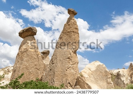 Fairy Chimneys located near Cavusin. Unique geological geological formations. Cappadocia, Nevsehir, Turkey (Turkiye) Royalty-Free Stock Photo #2438779507