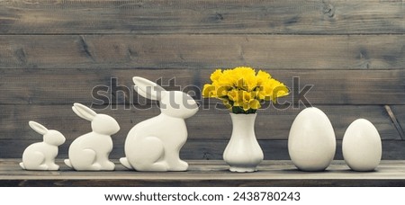 narcissus flowers with easter bunny and eggs decoration. retro style toned picture