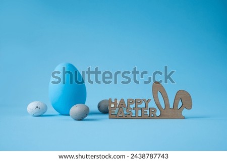 Happy Easter, colorful decorative eggs on blue background and Happy Easter lettering. Place for text, backgrounds for Easter