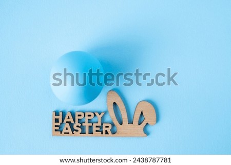Blue egg and lettering Happy Easter on blue background
