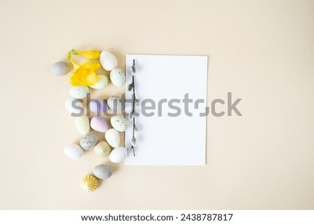 white sheet of paper with sweet dessert in the form of eggs for Easter. Background for an Easter card.