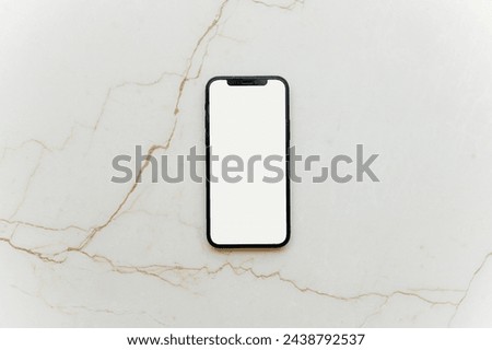 Flat lay Smartphone with blank white screen and copy-space on marble table