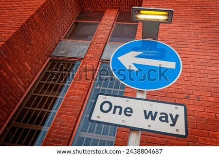 One way street sign with blue circle