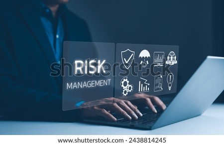 Corporate risk management strategy concept. A businessman is analyzing a virtual risk management interface with critical strategy icons on a laptop screen. Analyze risk assessment, analysis financial, Royalty-Free Stock Photo #2438814245