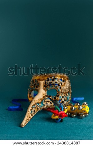 Beautiful multicolor carnival mask on a blue background. Purim, Mardi Gras holiday concept. Vertical Banner