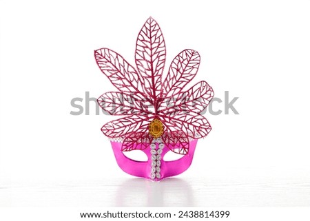Beautiful multicolor carnival mask on a white background. Purim, Mardi Gras holiday concept. Banner