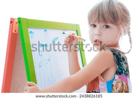 happy child draws on easel on a white background