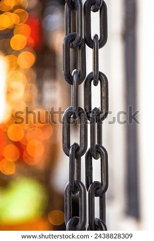 Hanging stainless-steel chains in varying depth of field and focus
