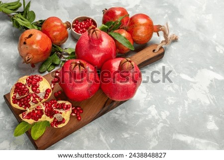 half-top view fresh red pomegranates sour and mellow fruits on light white desk fruit fresh mellow ripe tree Royalty-Free Stock Photo #2438848827