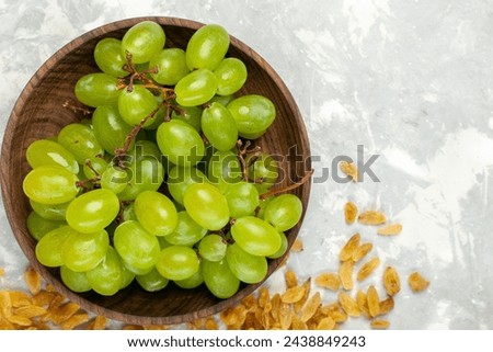 top view fresh green grapes mellow and delicious with raisins on light-white desk fruit fresh mellow tropical Royalty-Free Stock Photo #2438849243