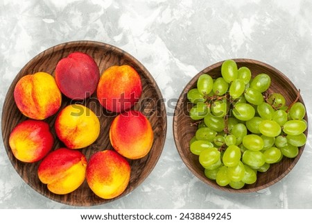 top view fresh green grapes mellow and delicious with peaches on light-white desk fruit fresh mellow tropical Royalty-Free Stock Photo #2438849245